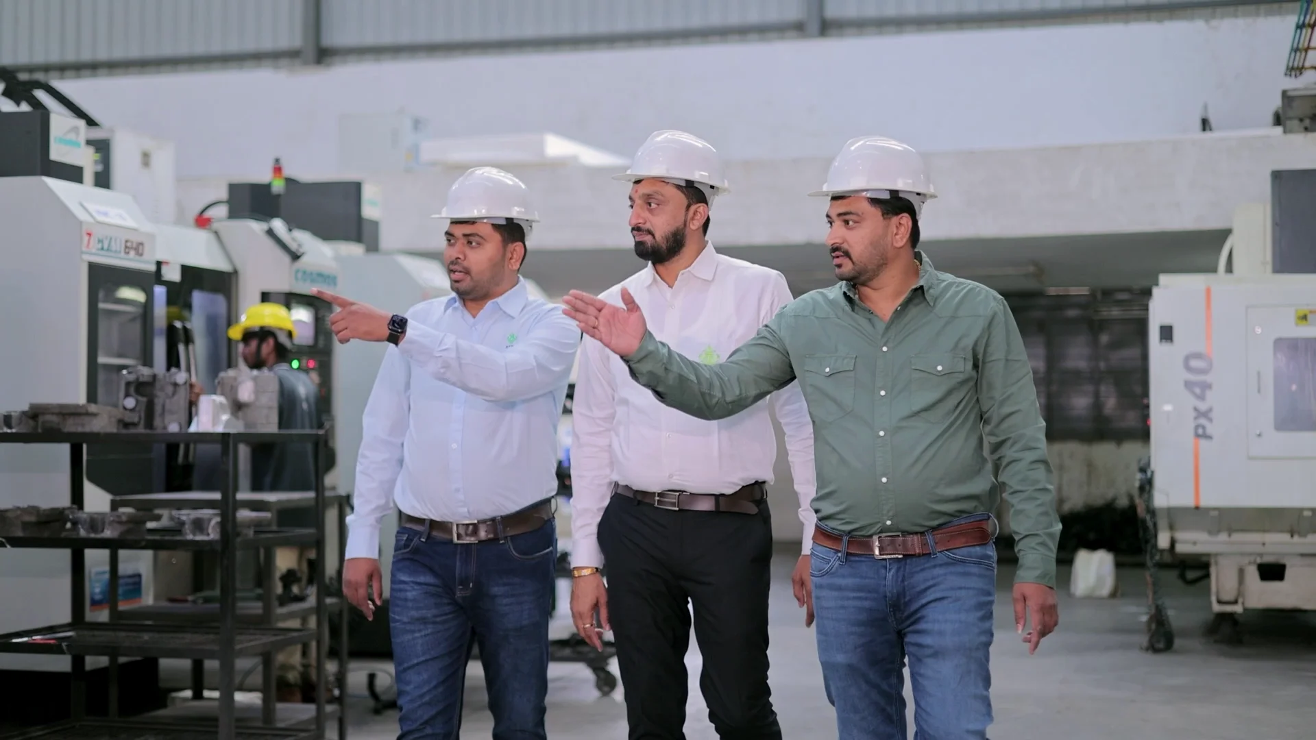 PTPL team members discussing work on the manufacturing floor